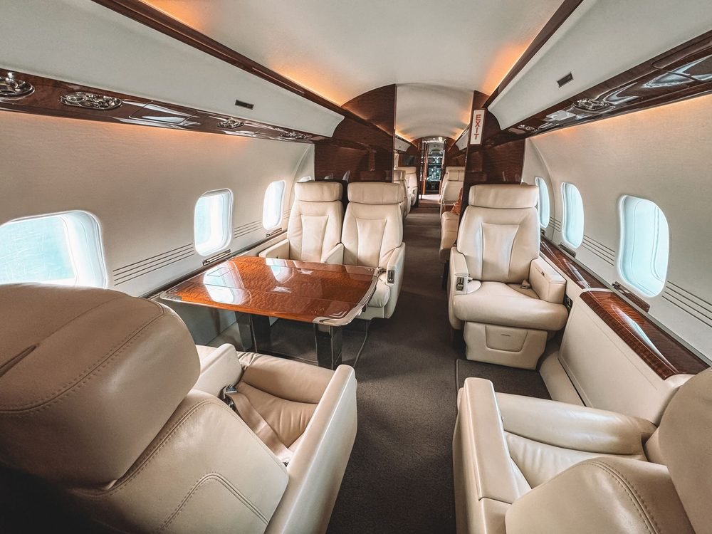 Cabin interior of a private jet with cream leather seating
